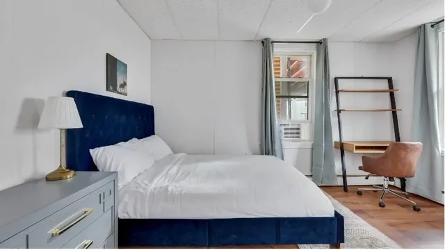 a bedroom with a bed and window