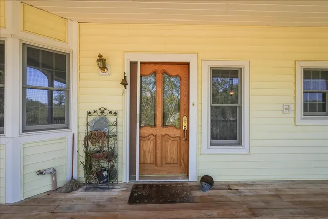 a kitchen with stainless steel appliances kitchen island granite countertop a stove a sink dishwasher and a dining table with wooden floor