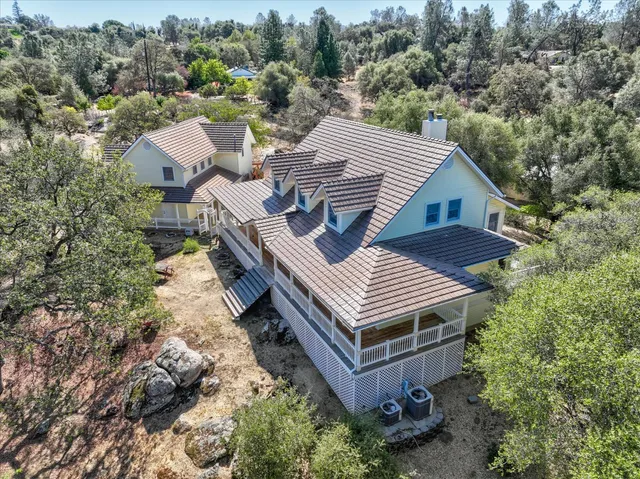 an aerial view of a house with a yard