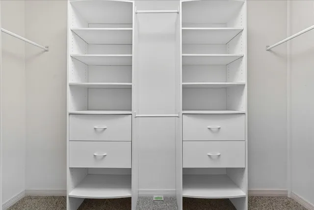 a view of a wooden house with a yard and wooden fence