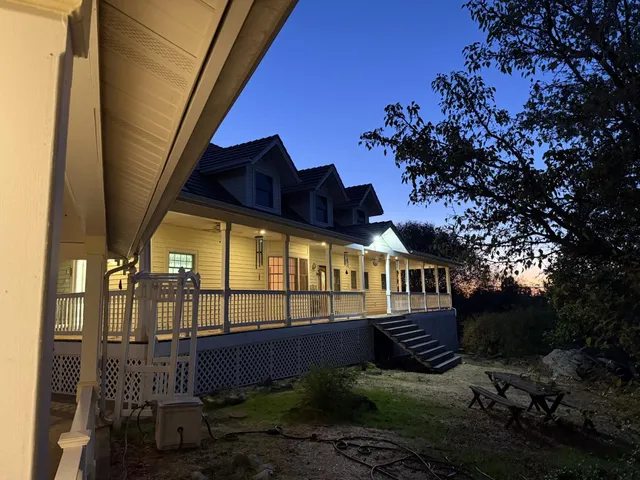 a view of a balcony with wooden floor and door