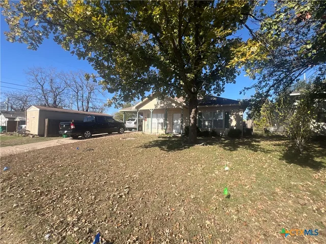 a view of road with large trees