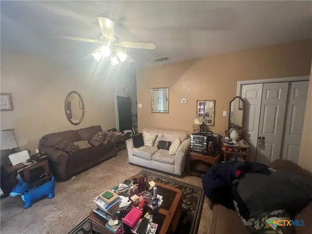 a living room with furniture a rug and a chandelier