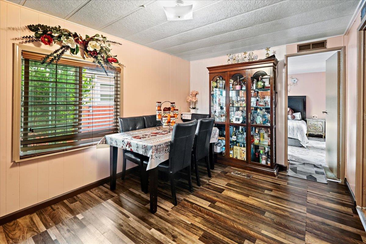 13607 Monte Del Sol, Unit 127 Castroville, CA 95012 - Photo 11 of 27 a dining room with wooden floor and a table