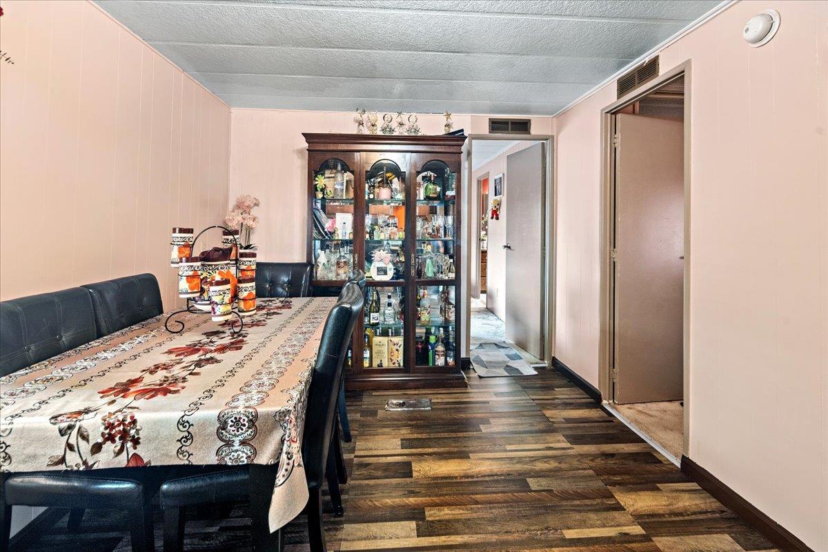 13607 Monte Del Sol, Unit 127 Castroville, CA 95012 - Photo 12 of 27 a view of a dining room with furniture and wooden floor