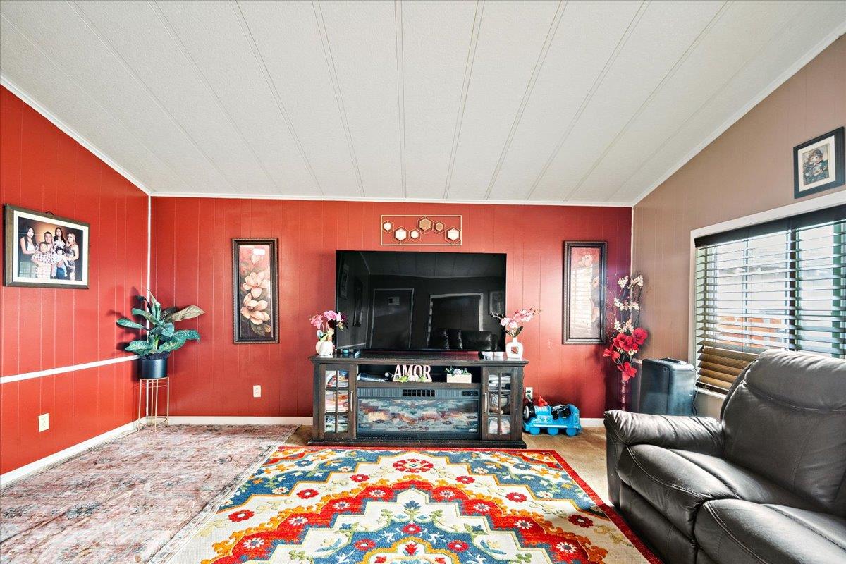 13607 Monte Del Sol, Unit 127 Castroville, CA 95012 - Photo 16 of 27 a living room with furniture and a flat screen tv