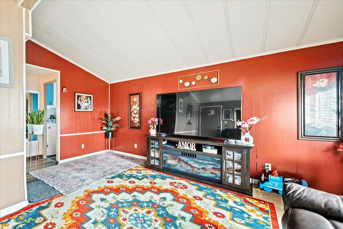 13607 Monte Del Sol, Unit 127 Castroville, CA 95012 - Photo 17 of 27 a living room with furniture and a flat screen tv