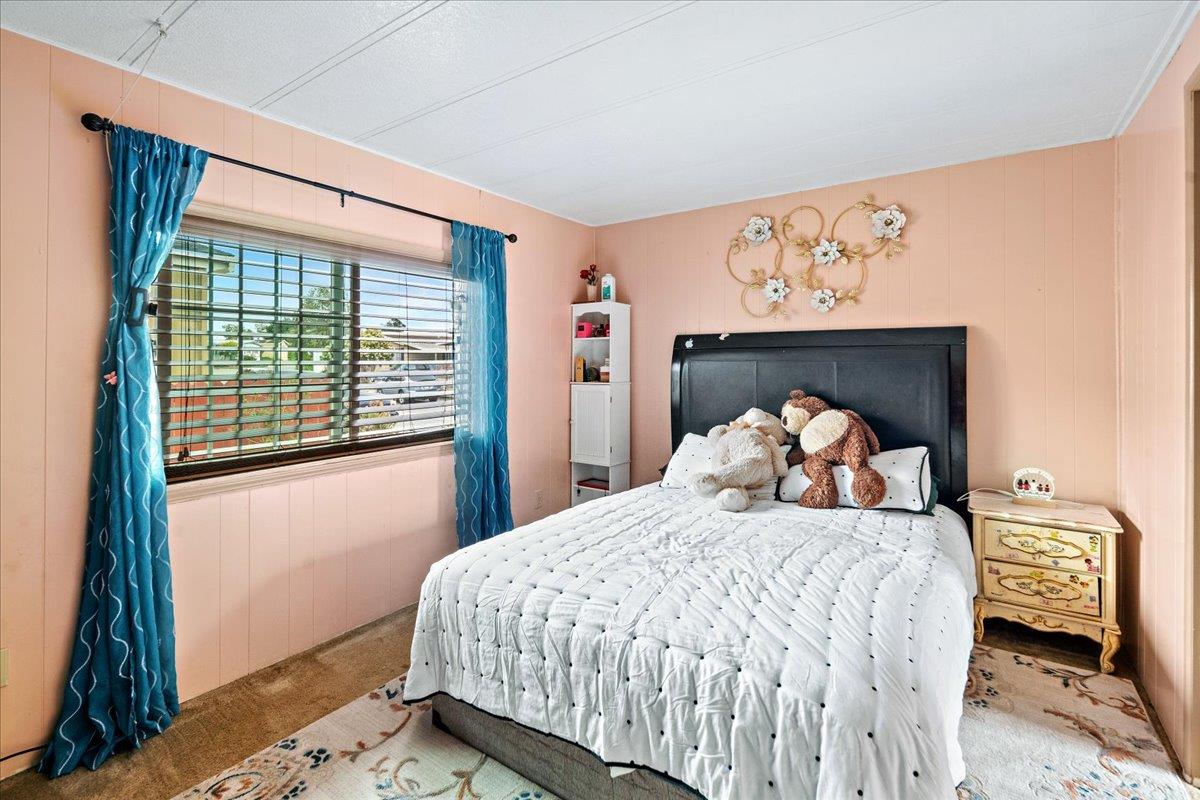 13607 Monte Del Sol, Unit 127 Castroville, CA 95012 - Photo 19 of 27 a bedroom with a bed and a window