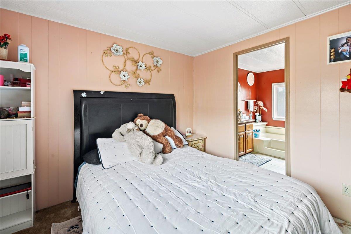 13607 Monte Del Sol, Unit 127 Castroville, CA 95012 - Photo 20 of 27 a bedroom with a bed and a window