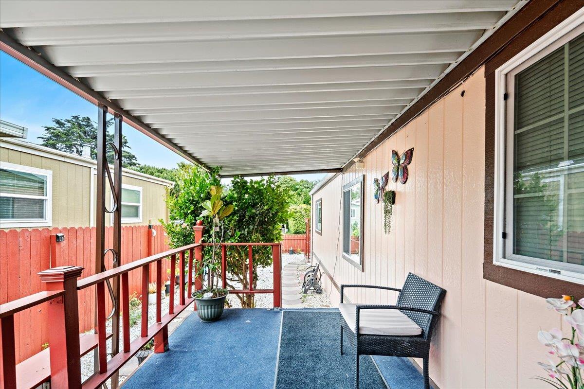 13607 Monte Del Sol, Unit 127 Castroville, CA 95012 - Photo 3 of 27 a porch with wooden floor outdoor seating and furniture