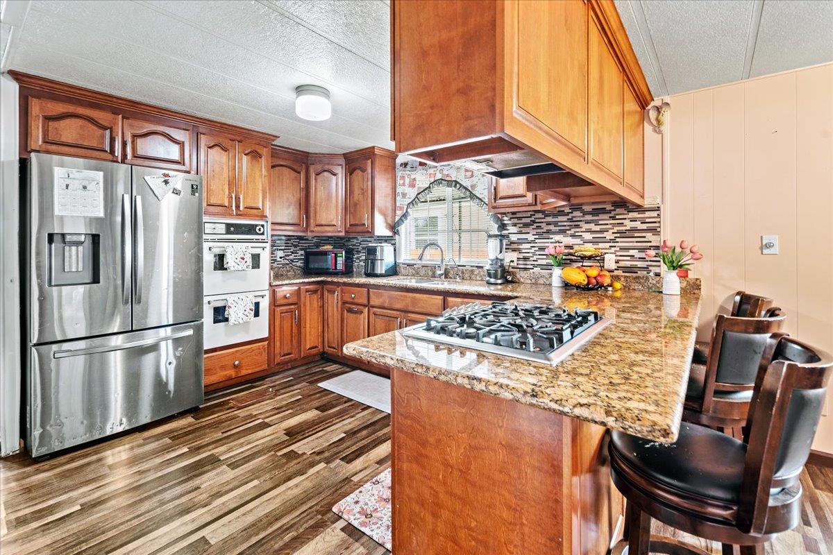13607 Monte Del Sol, Unit 127 Castroville, CA 95012 - Photo 4 of 27 a kitchen with stainless steel appliances granite countertop a sink stove and refrigerator
