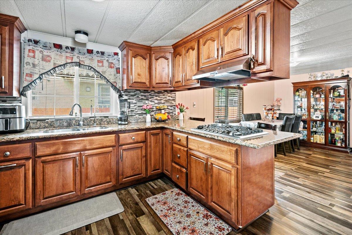 13607 Monte Del Sol, Unit 127 Castroville, CA 95012 - Photo 5 of 27 a kitchen with stainless steel appliances granite countertop a stove a sink and a refrigerator