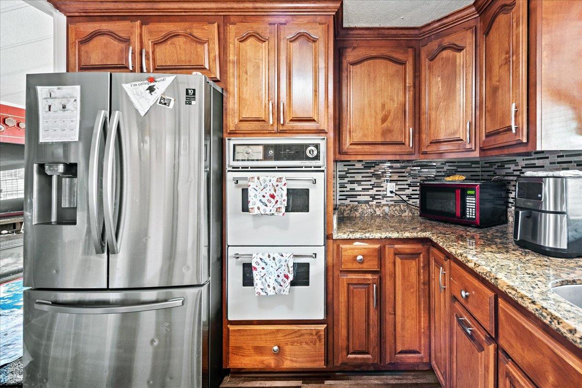 13607 Monte Del Sol, Unit 127 Castroville, CA 95012 - Photo 6 of 27 a kitchen with stainless steel appliances granite countertop a refrigerator and a stove