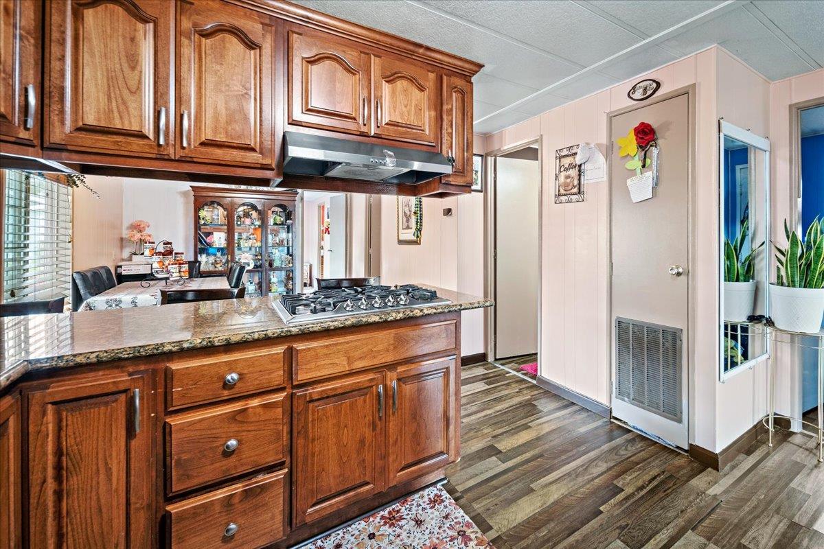 13607 Monte Del Sol, Unit 127 Castroville, CA 95012 - Photo 7 of 27 a kitchen with granite countertop stainless steel appliances a counter space and cabinets