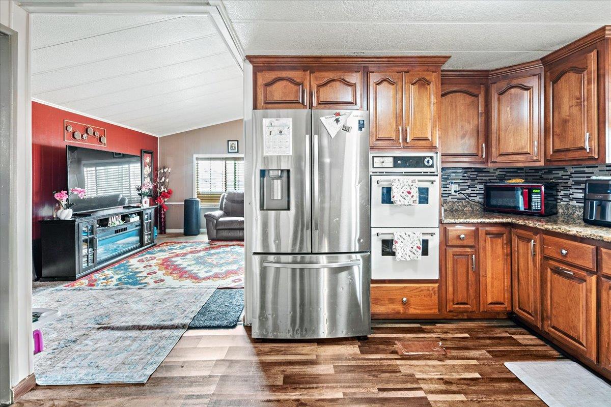13607 Monte Del Sol, Unit 127 Castroville, CA 95012 - Photo 9 of 27 a kitchen with stainless steel appliances granite countertop a refrigerator and a stove top oven