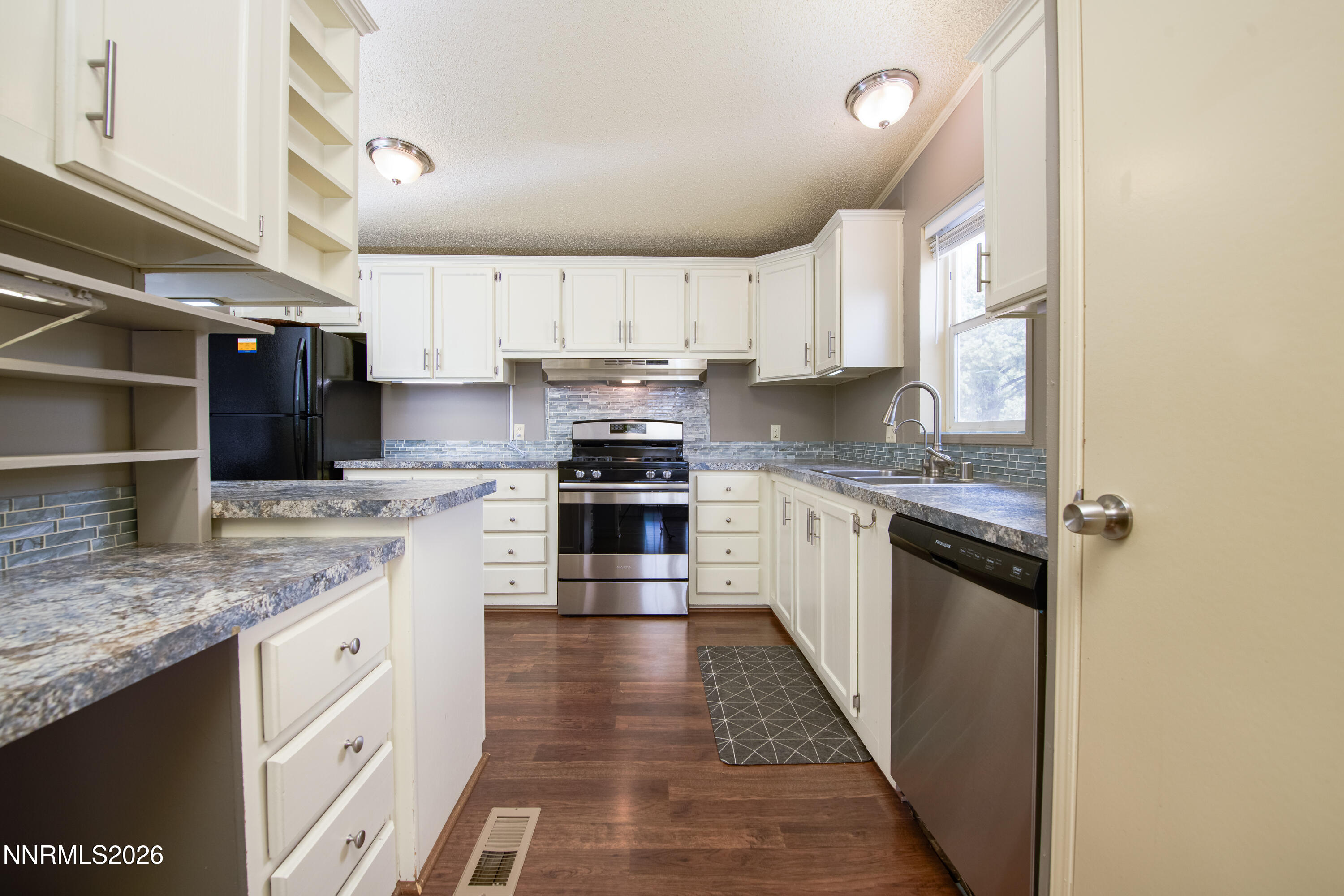 1355 Sandstone Drive Topaz Ranch Estates, NV 89444 - Photo 11 of 57 a kitchen with stainless steel appliances granite countertop a stove a sink and a refrigerator