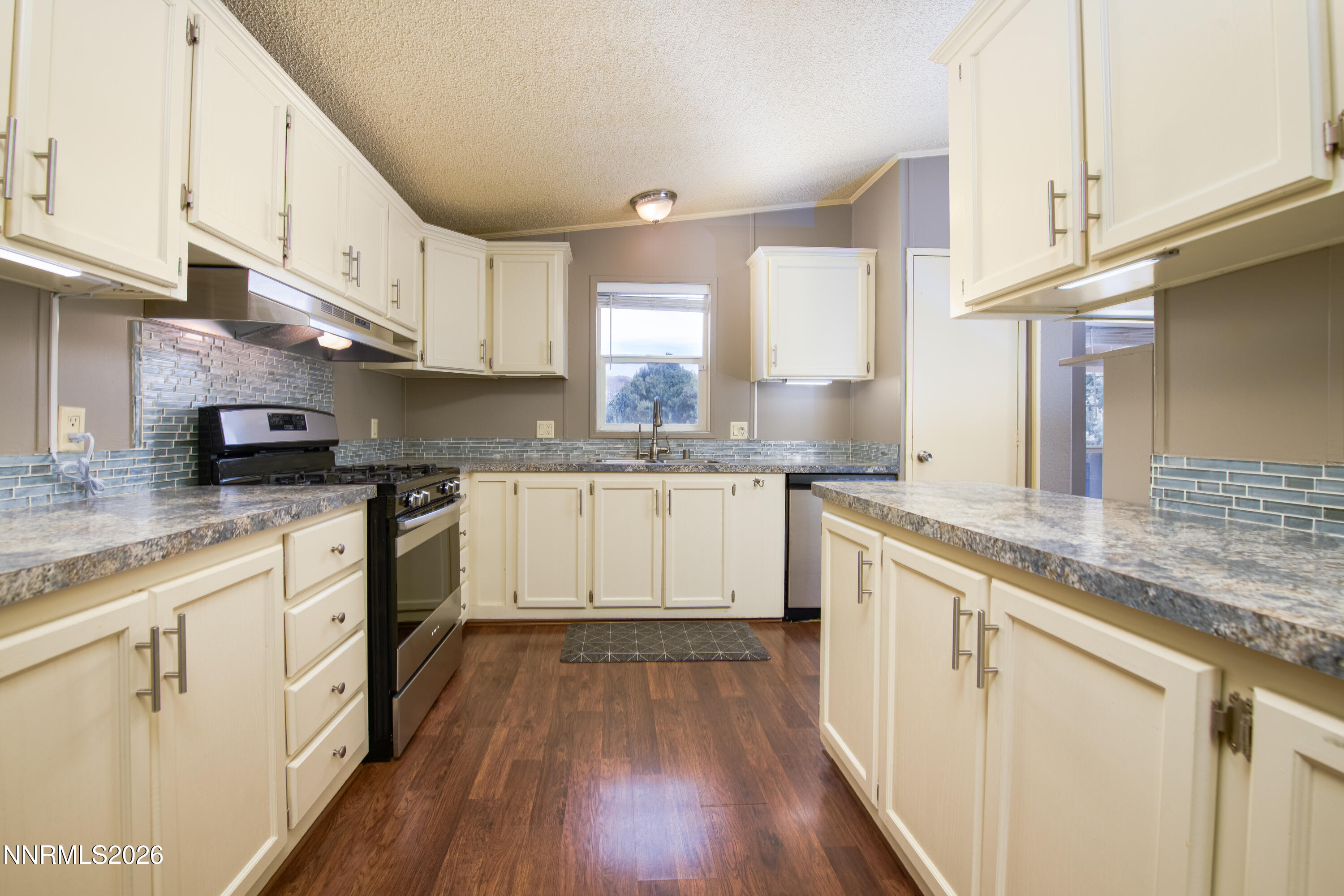 1355 Sandstone Drive Topaz Ranch Estates, NV 89444 - Photo 12 of 57 a kitchen with granite countertop white cabinets and white appliances