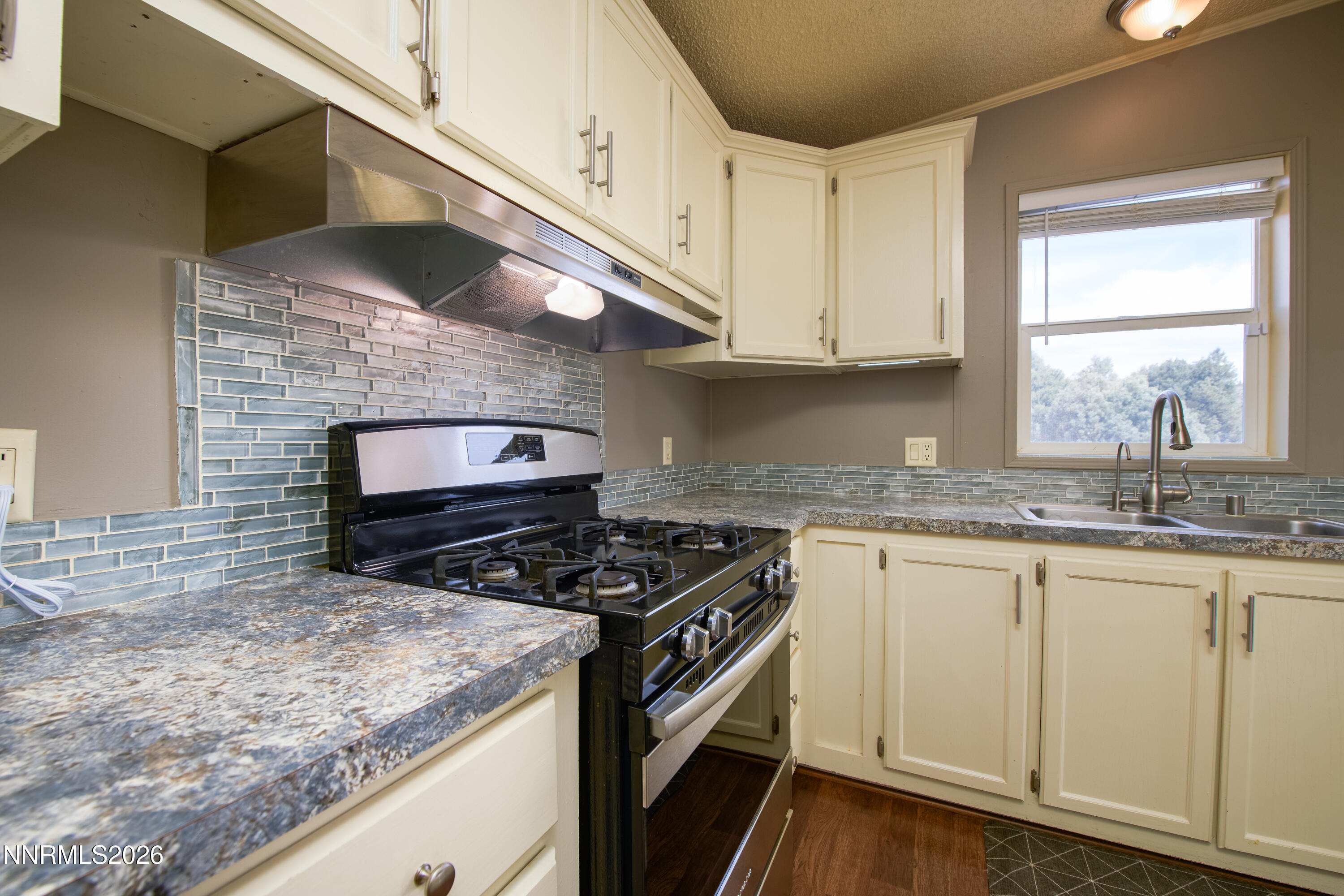 1355 Sandstone Drive Topaz Ranch Estates, NV 89444 - Photo 13 of 57 a kitchen with stainless steel appliances granite countertop a sink stove and cabinets