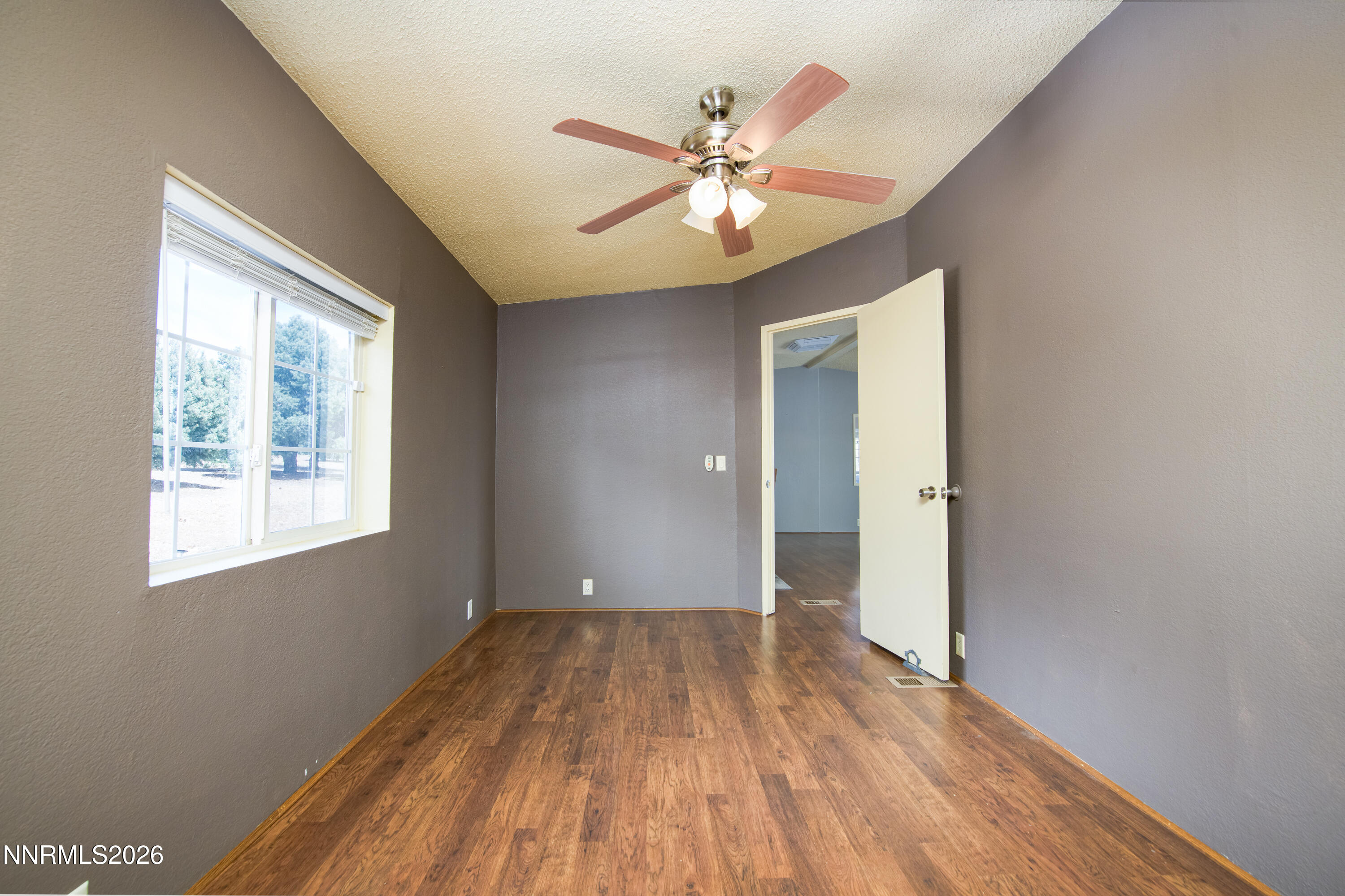 1355 Sandstone Drive Topaz Ranch Estates, NV 89444 - Photo 18 of 57 a view of an empty room with wooden floor and a window
