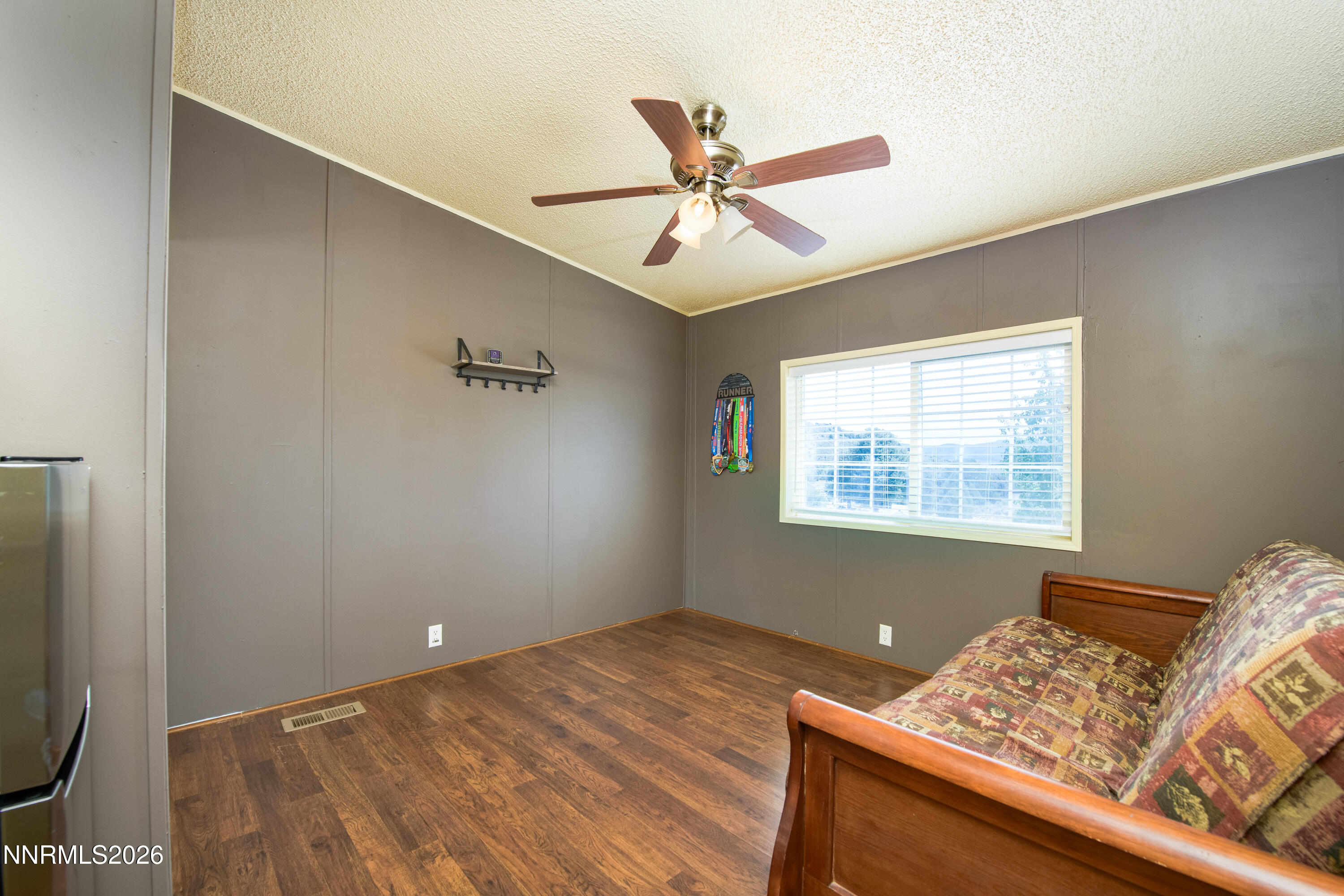 1355 Sandstone Drive Topaz Ranch Estates, NV 89444 - Photo 20 of 57 a view of a bedroom with wooden floor and fan