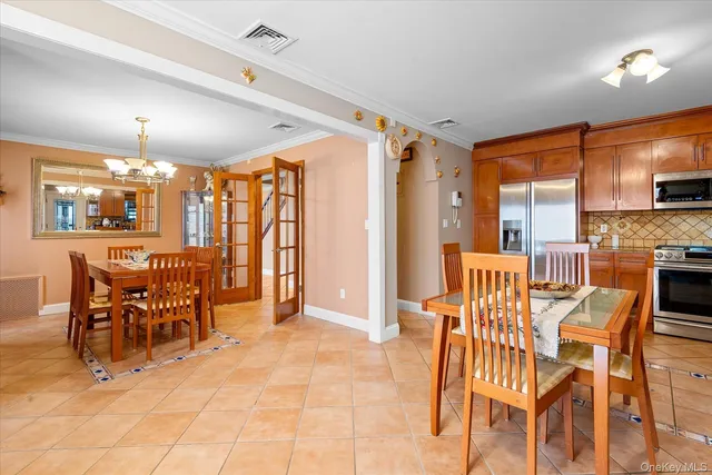 a view of a dining room with furniture and chandelier