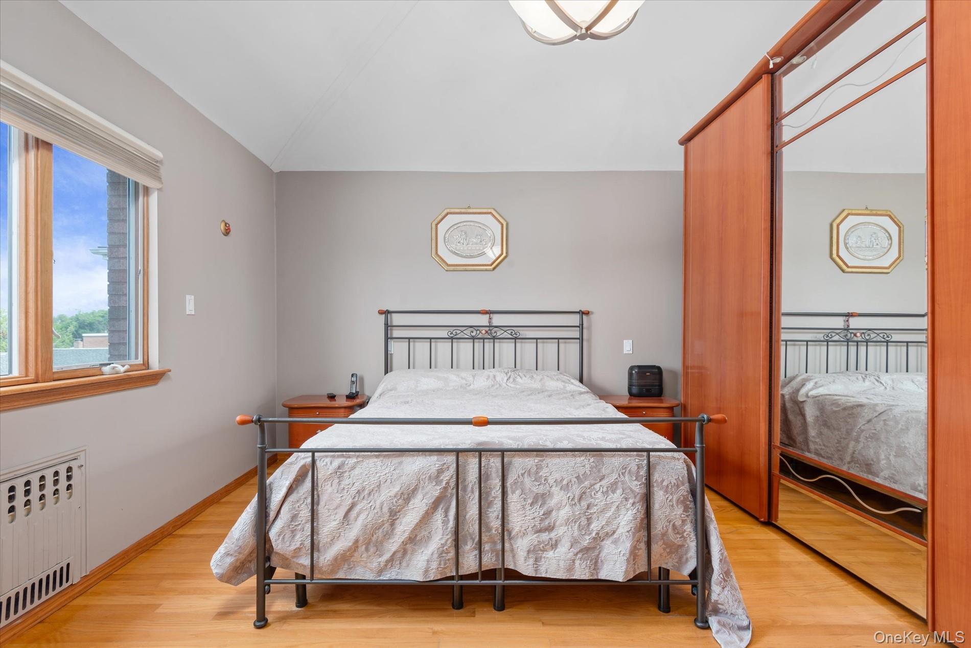 21-34 74th Street Queens, NY 11370 - Photo 15 of 20 a bedroom with a bed and a window