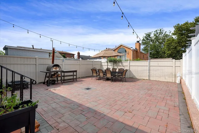 a view of a patio with a table and chairs