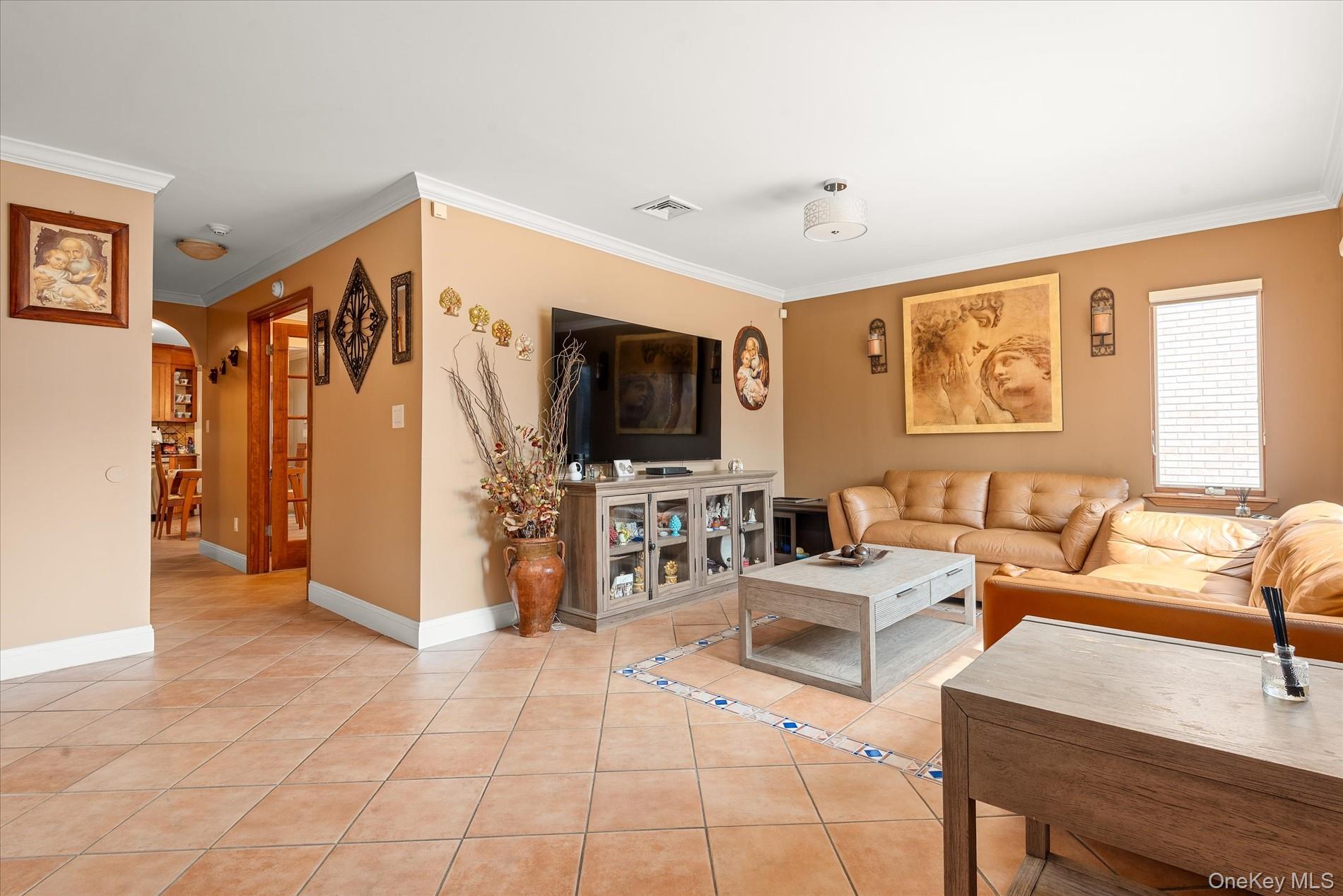 21-34 74th Street Queens, NY 11370 - Photo 4 of 20 a living room with furniture and a flat screen tv