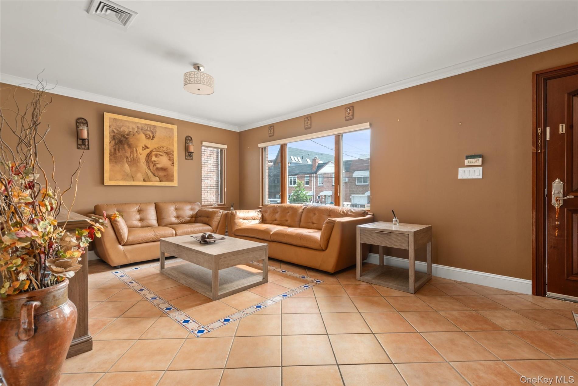 21-34 74th Street Queens, NY 11370 - Photo 5 of 20 a living room with furniture and a large window