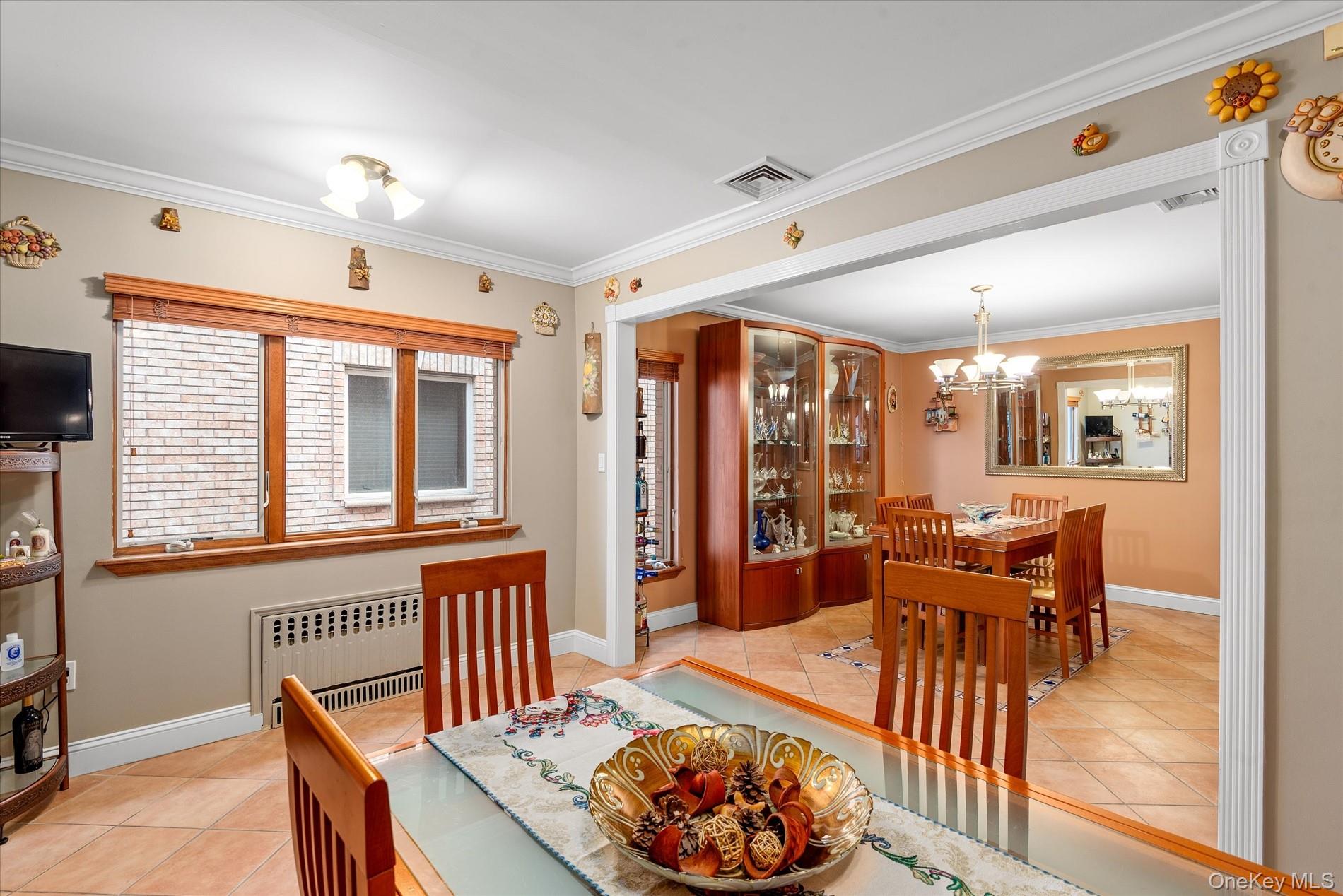 21-34 74th Street Queens, NY 11370 - Photo 7 of 20 a living room with furniture a rug and a large window