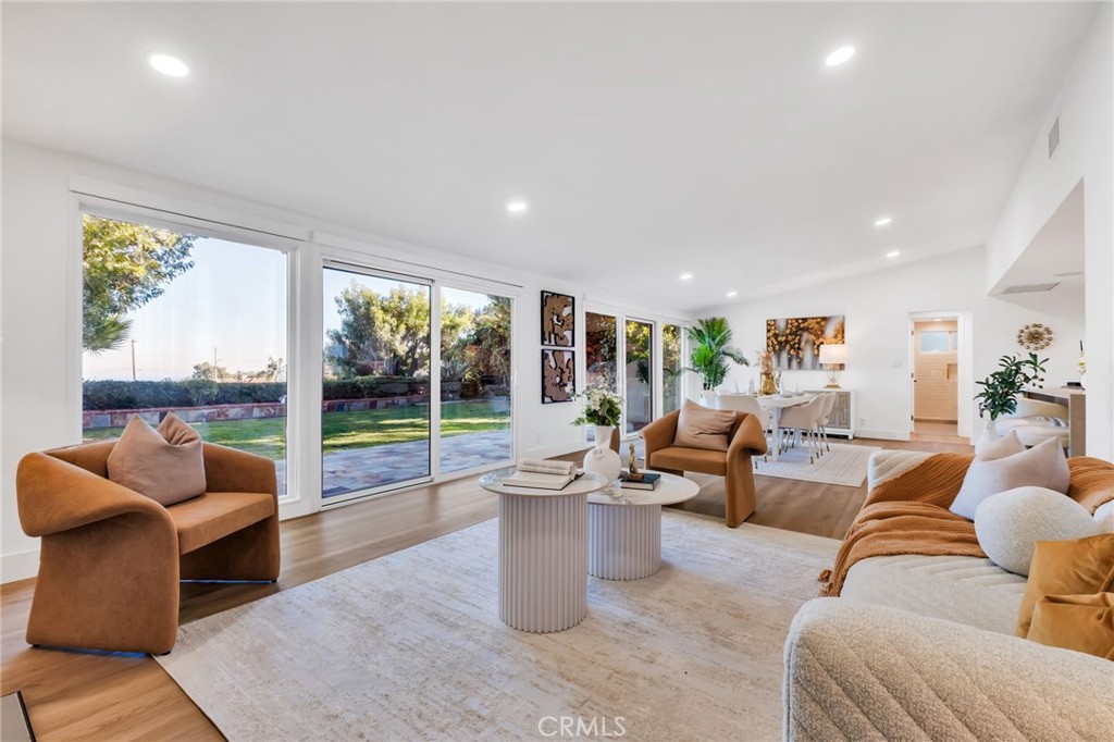 a living room with furniture and a floor to ceiling window