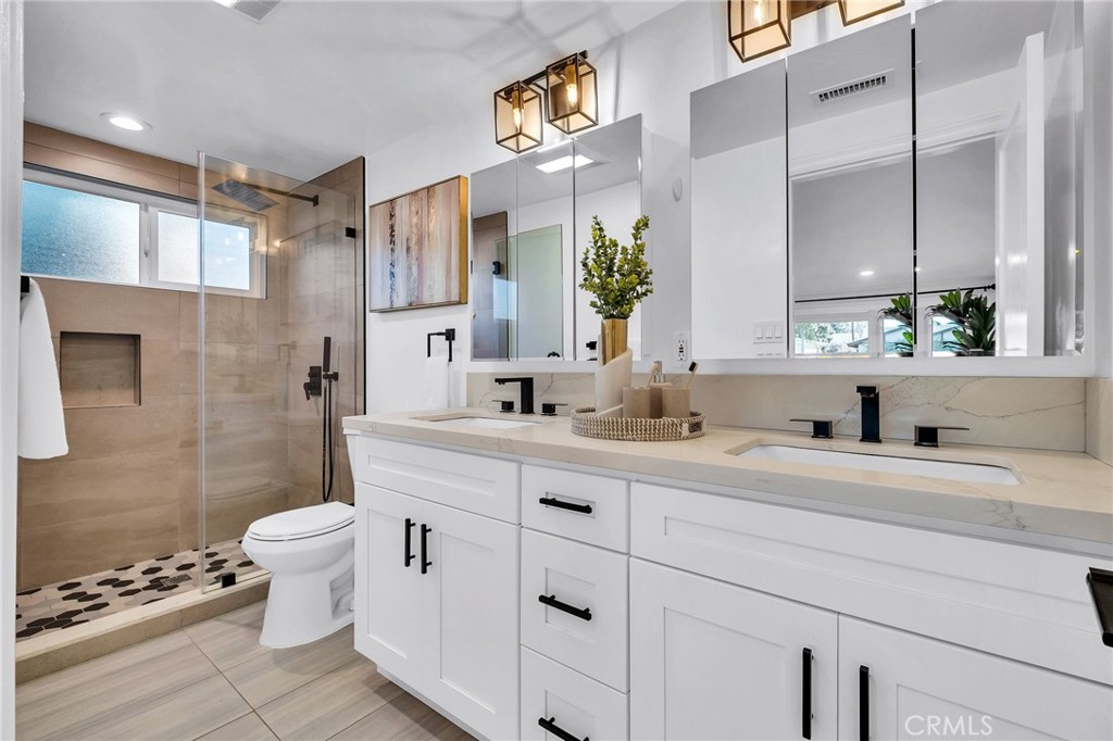 26700 Indian Peak Road Rancho Palos Verdes, CA 90275 - Photo 23 of 40 a bathroom with a double vanity sink toilet and shower
