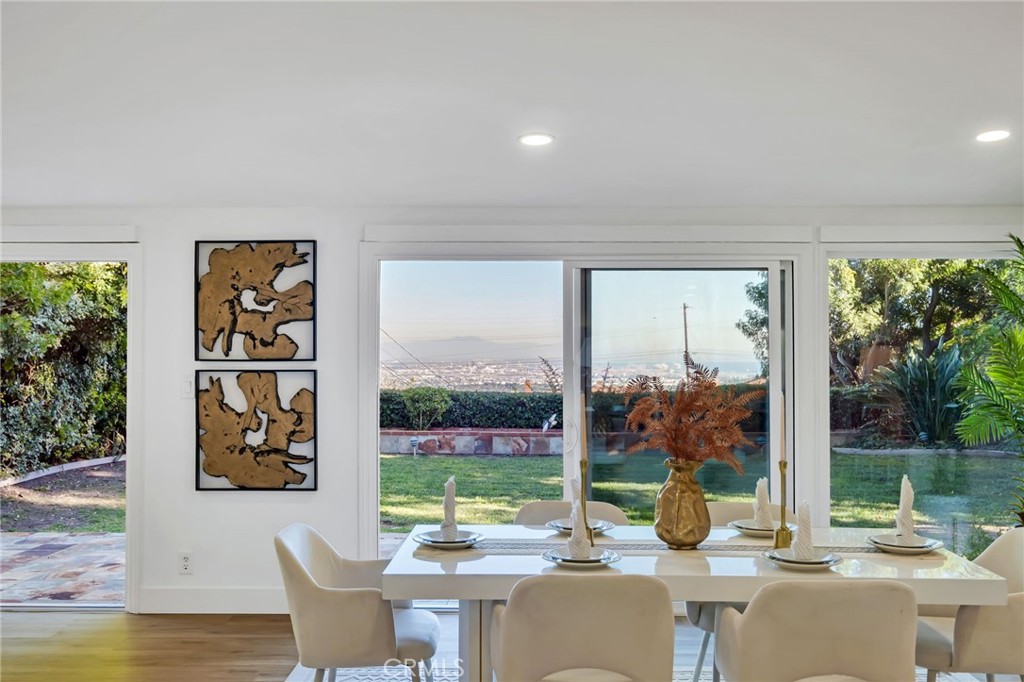 26700 Indian Peak Road Rancho Palos Verdes, CA 90275 - Photo 25 of 40 a view of a patio with table and chairs potted plants with wooden floor and fence