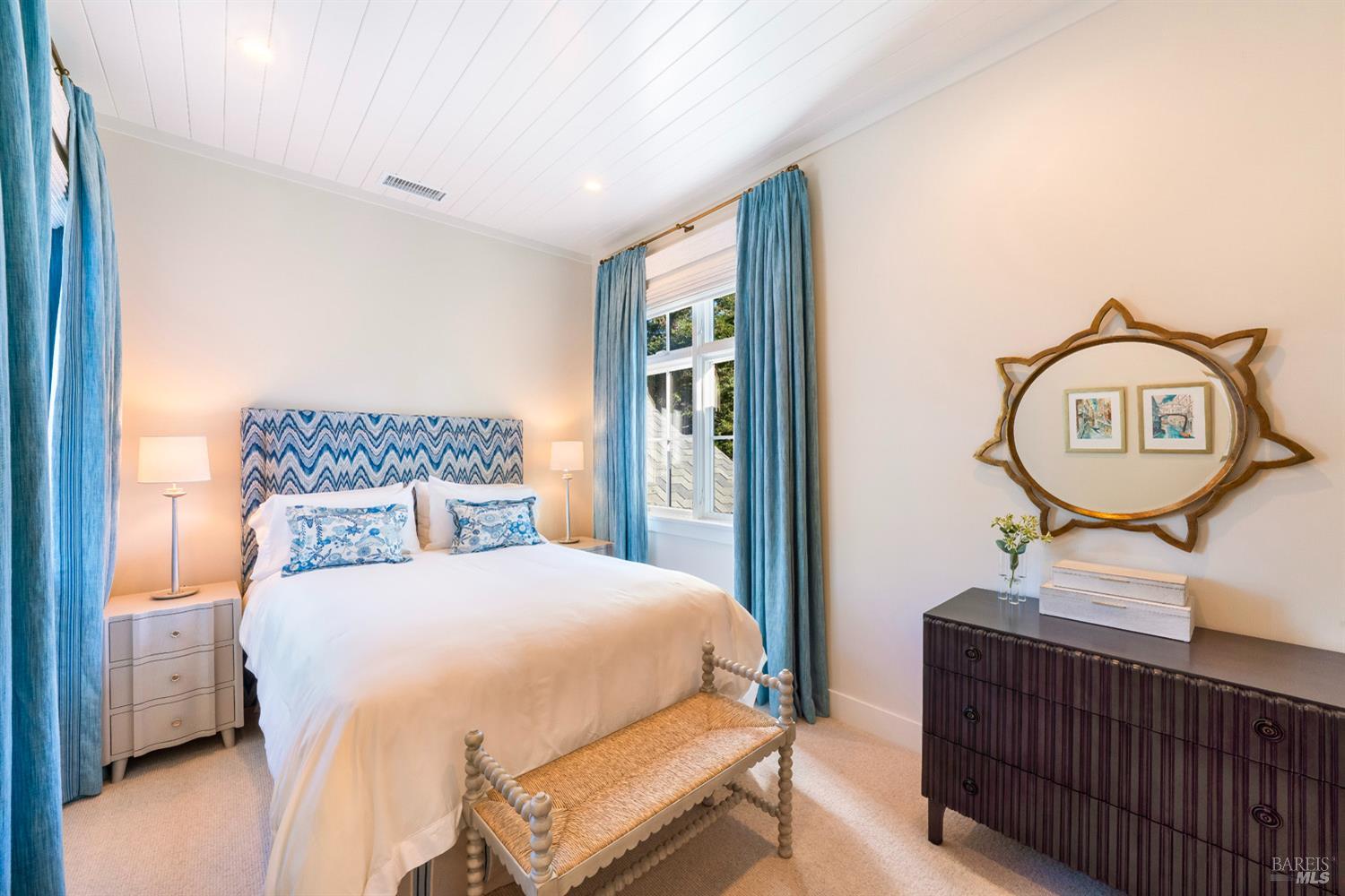 1711 Spring Street St. Helena, CA 94574 - Photo 27 of 38 a bedroom with a bed a mirror on the wall and dresser