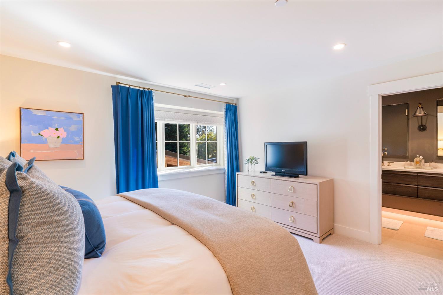 1711 Spring Street St. Helena, CA 94574 - Photo 29 of 38 a bedroom with a bed and a flat screen tv