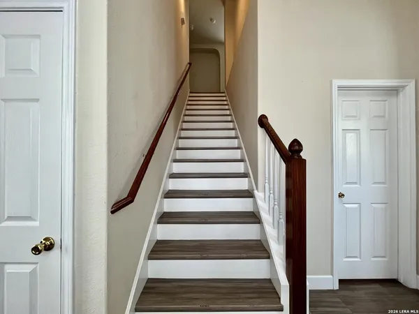 a view of a hallway with wooden floor and entryway