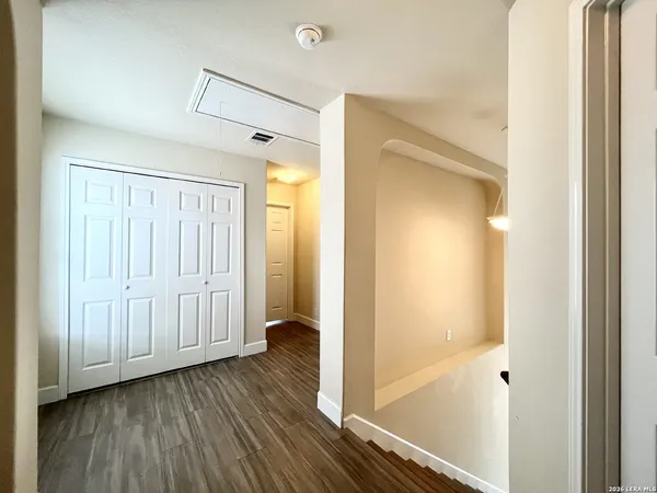 a view of a hallway with wooden floor