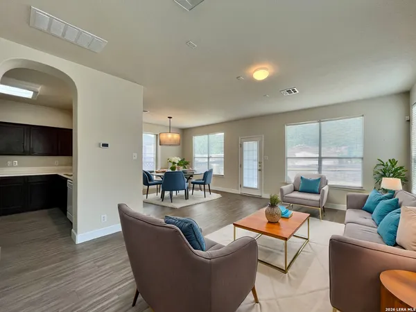 a living room with fireplace furniture and a large window