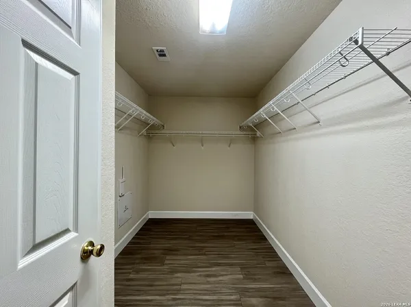 a view of a hallway with wooden floor and entryway