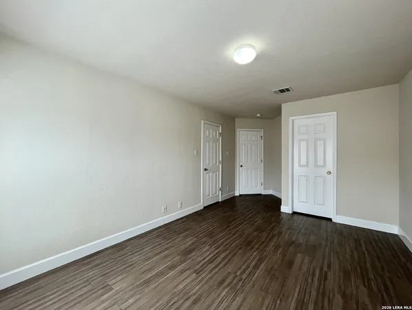 a view of an empty room and wooden floor