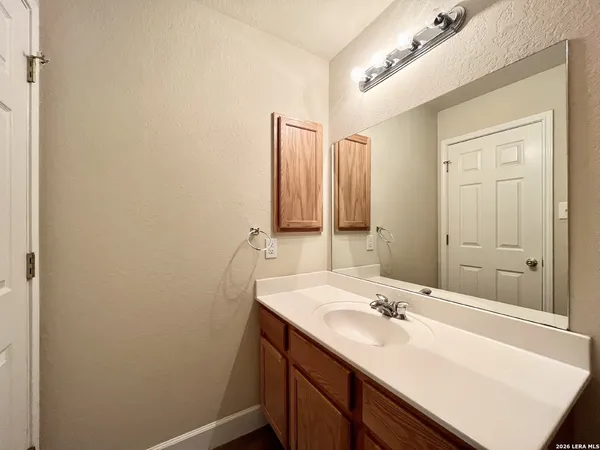 a bathroom with a sink a vanity and a mirror