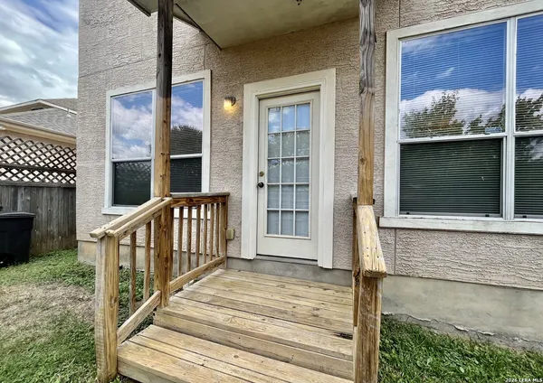 a view of balcony with wooden floor and fence