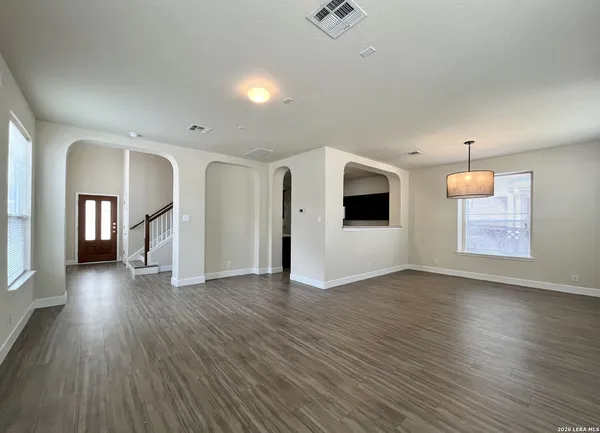a view of a livingroom with wooden floor and a fireplace