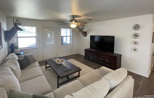 a living room with furniture and a flat screen tv