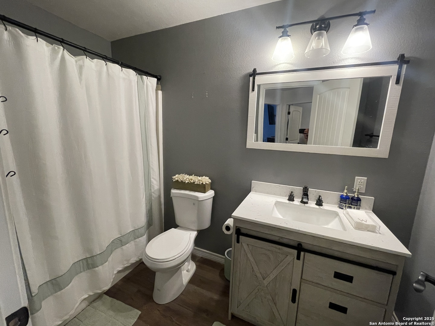 1408 33rd Street Hondo, TX 78861 - Photo 15 of 19 a bathroom with a sink a toilet and mirror