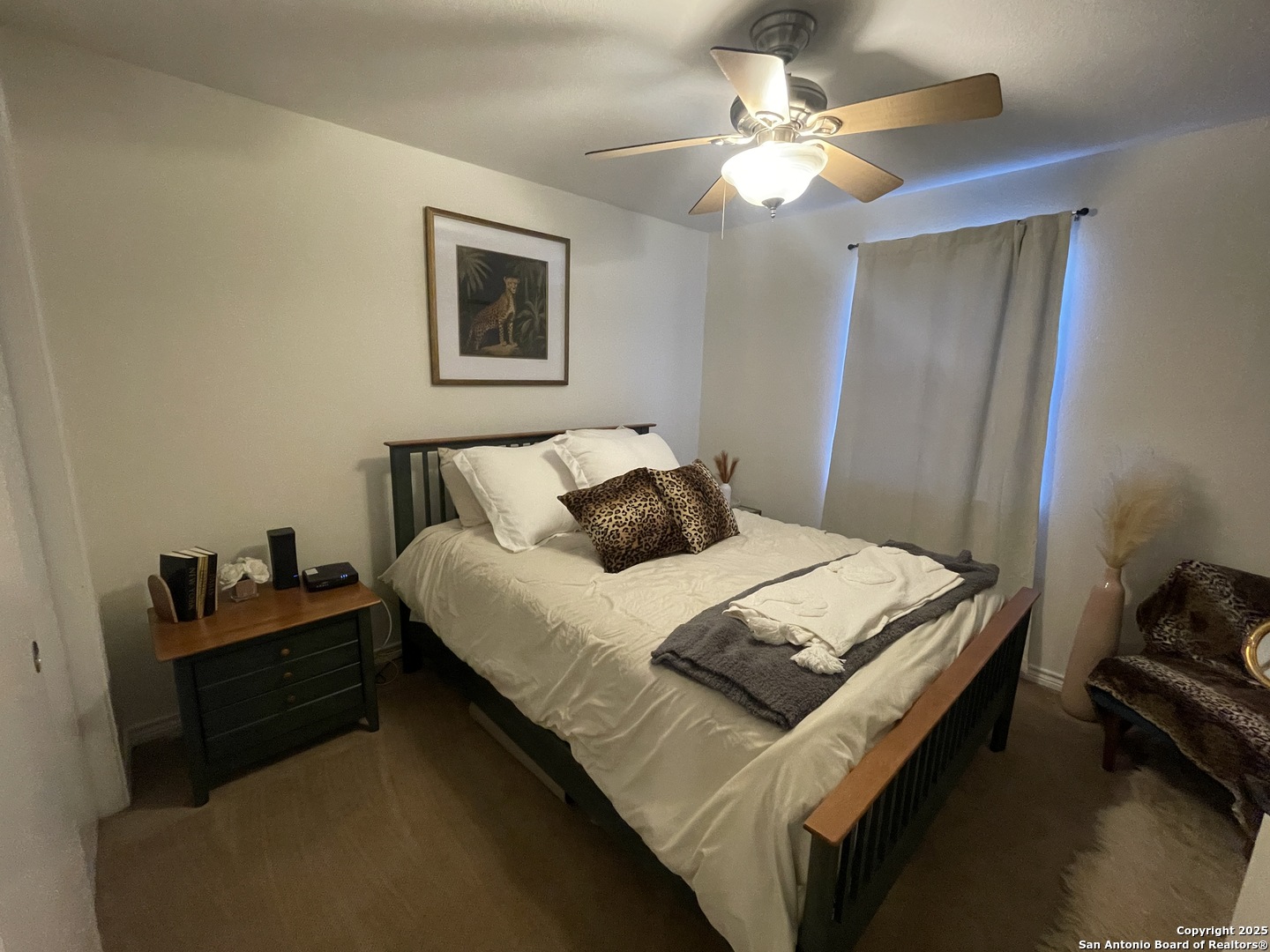 1408 33rd Street Hondo, TX 78861 - Photo 16 of 19 a bedroom with a bed and a chandelier