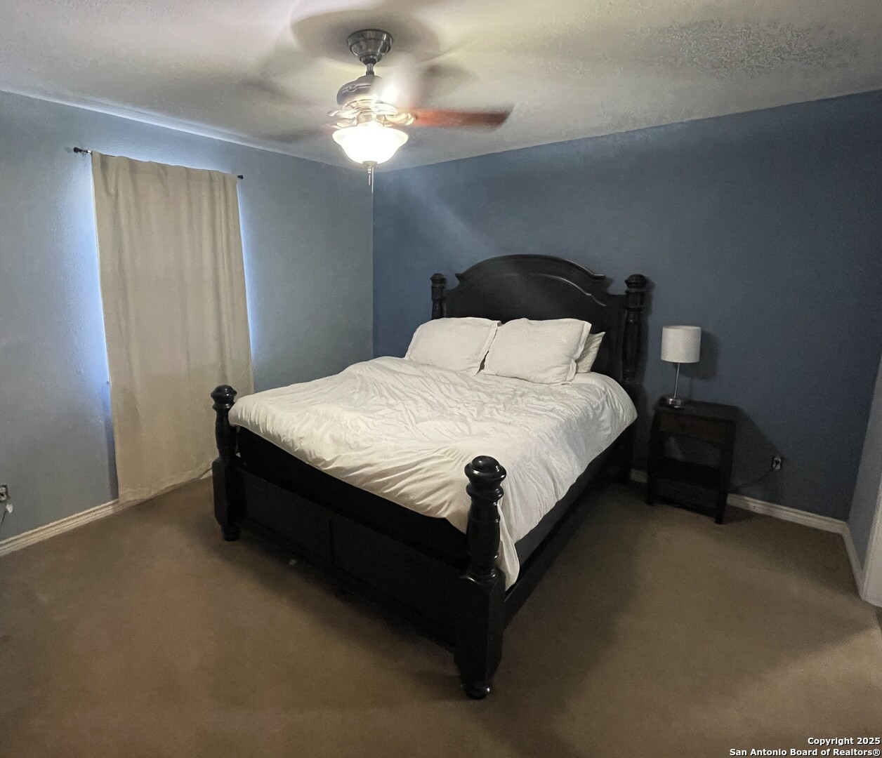 1408 33rd Street Hondo, TX 78861 - Photo 17 of 19 a spacious bedroom with a bed and a chandelier