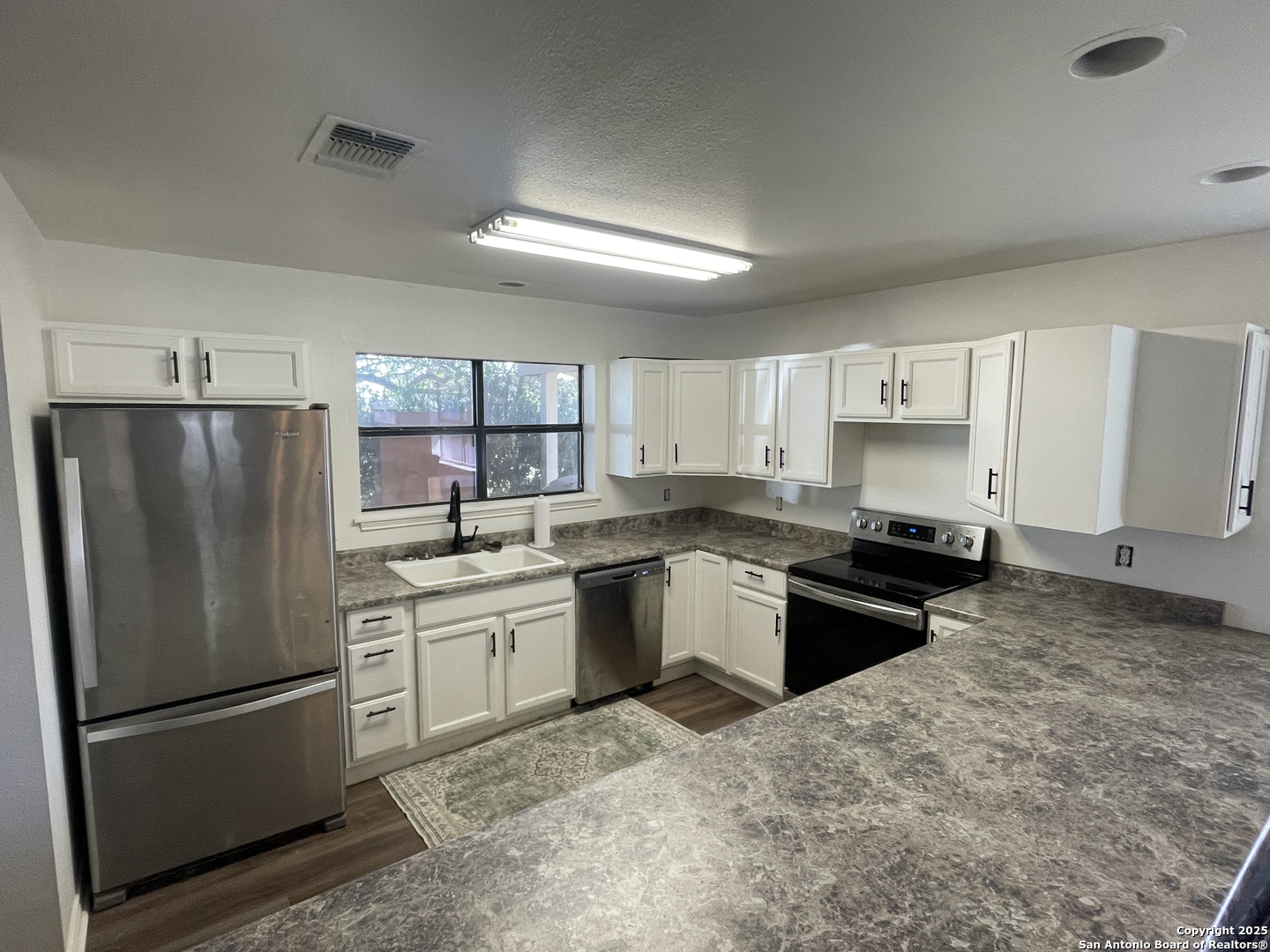 1408 33rd Street Hondo, TX 78861 - Photo 7 of 19 a kitchen with a refrigerator stove and sink