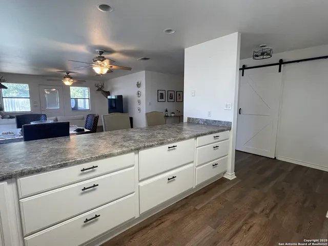 a bathroom with a granite countertop sink mirror and vanity