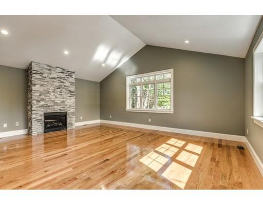 7 Tremlett Road Billerica, MA 01821 - Photo 13 of 30 a view of an empty room with wooden floor and a fireplace